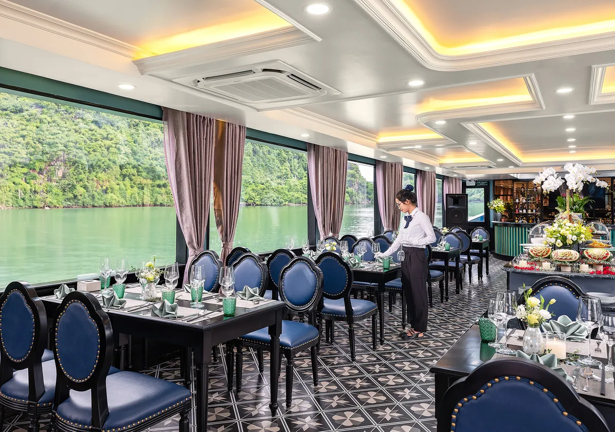 Sea Lion Premium Cruise restaurant seating with warm lighting and bay backdrop